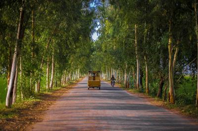 Car and a motorcycle on a small village road in Punjab, Pakistan