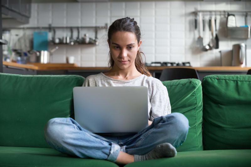 A self-employed worker with a laptop on her knees