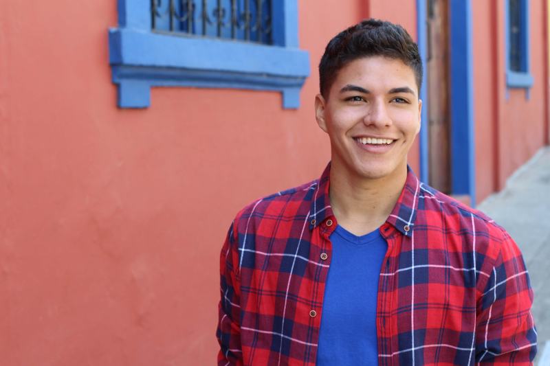 A young Hispanic man looking at the camera.