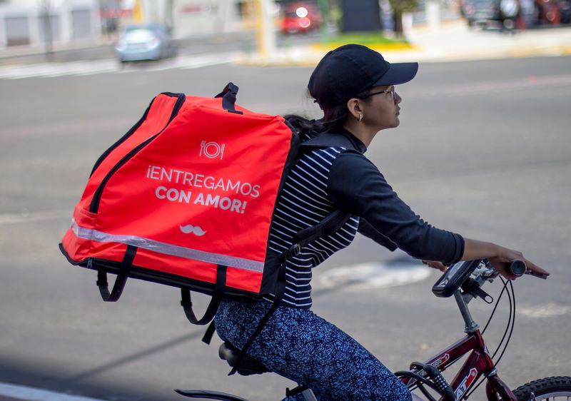 A delivery worker on her bike