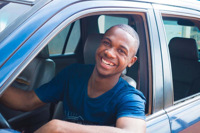 A taxi driver in his car